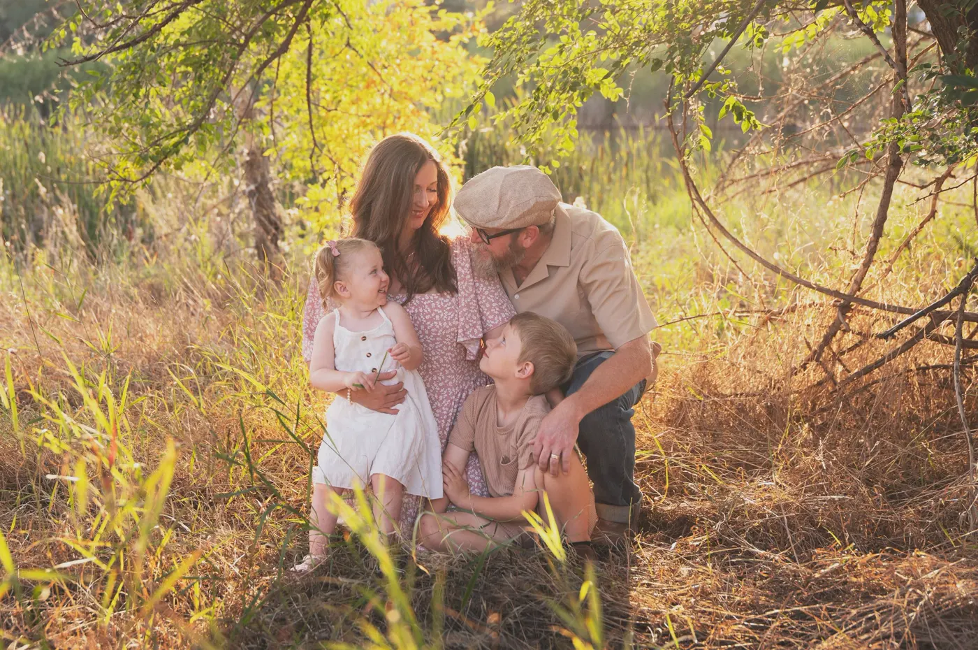 Thom with his wife and two kids in tall prairie grass